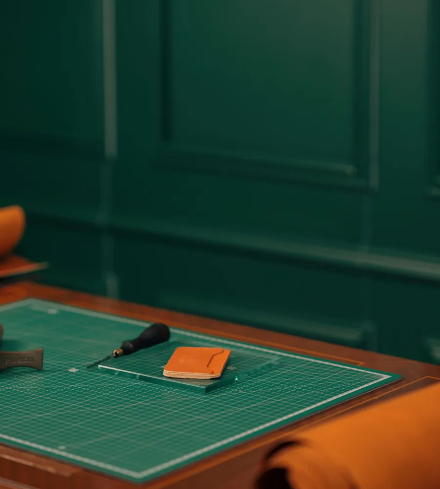 Refined leathercraft workspace with rolls, tools, and finished goods