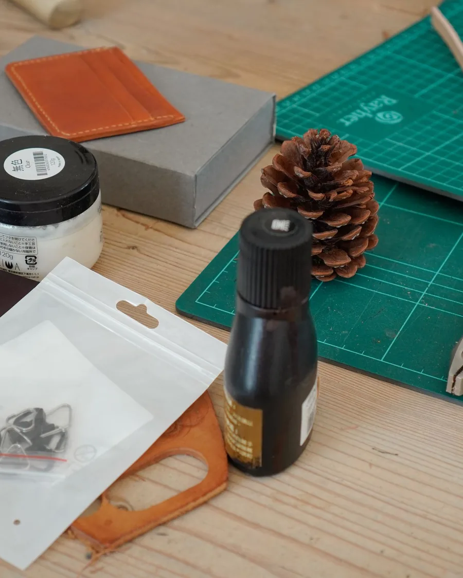 Leathercraft starter tools and materials arranged on a workshop table