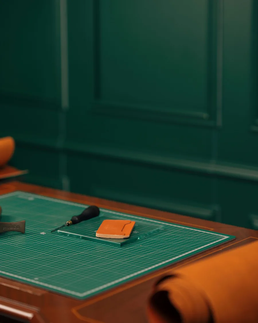 Organized leathercraft workbench with tools and leather pieces