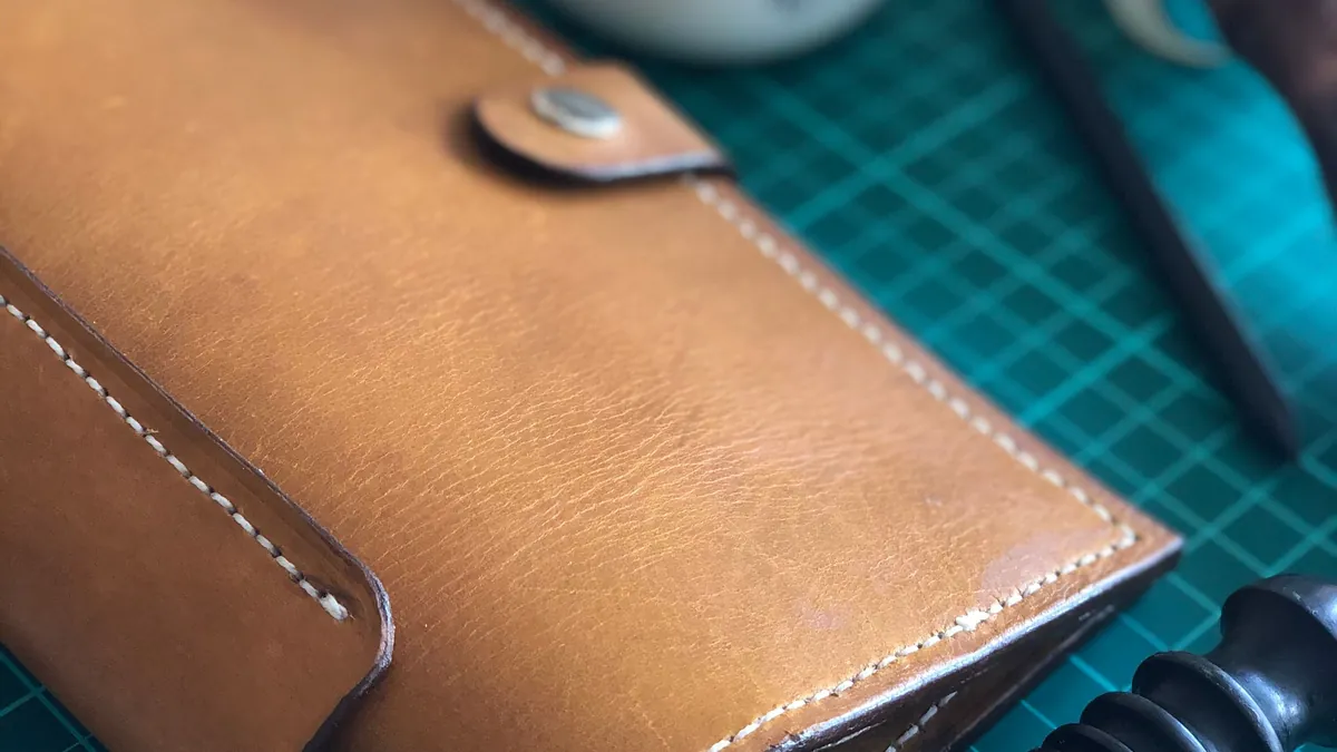 Finished wallet showing clean edges and detailed stitching