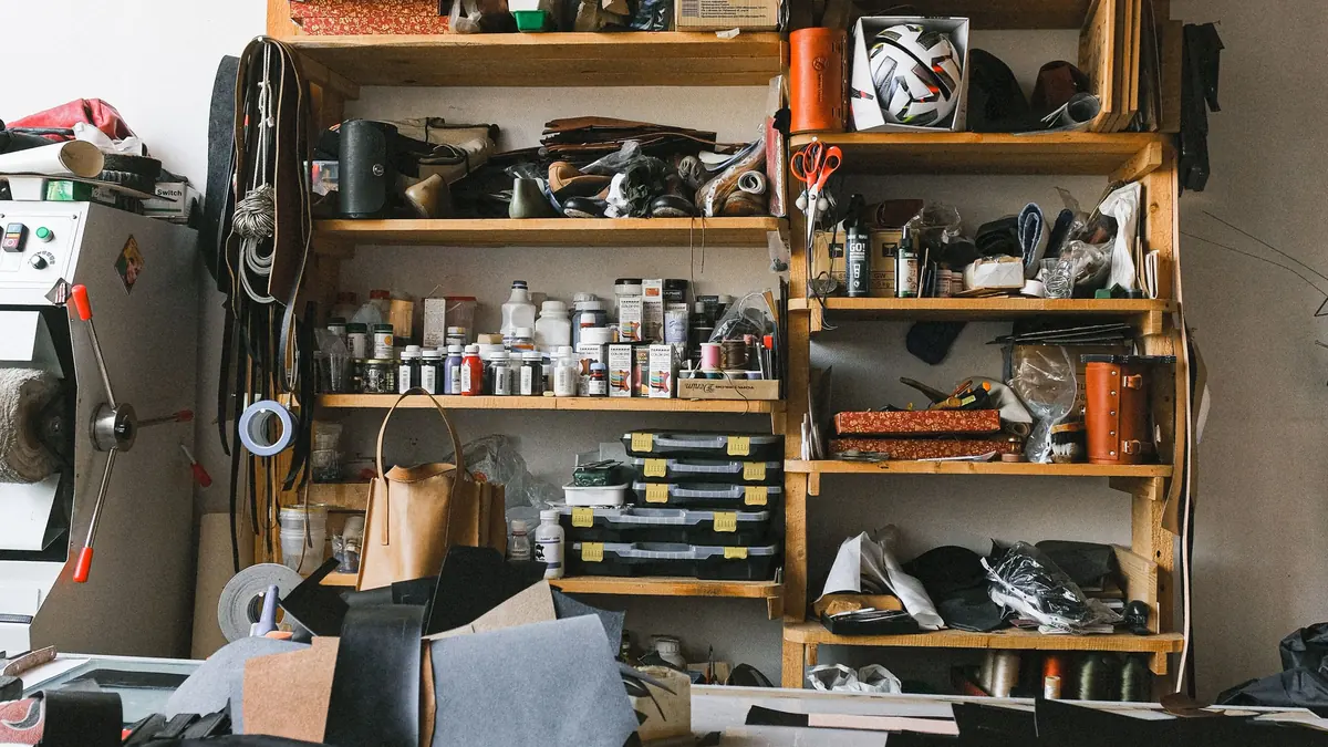 Leathercraft workshop organized with patterns, tools, and shelves